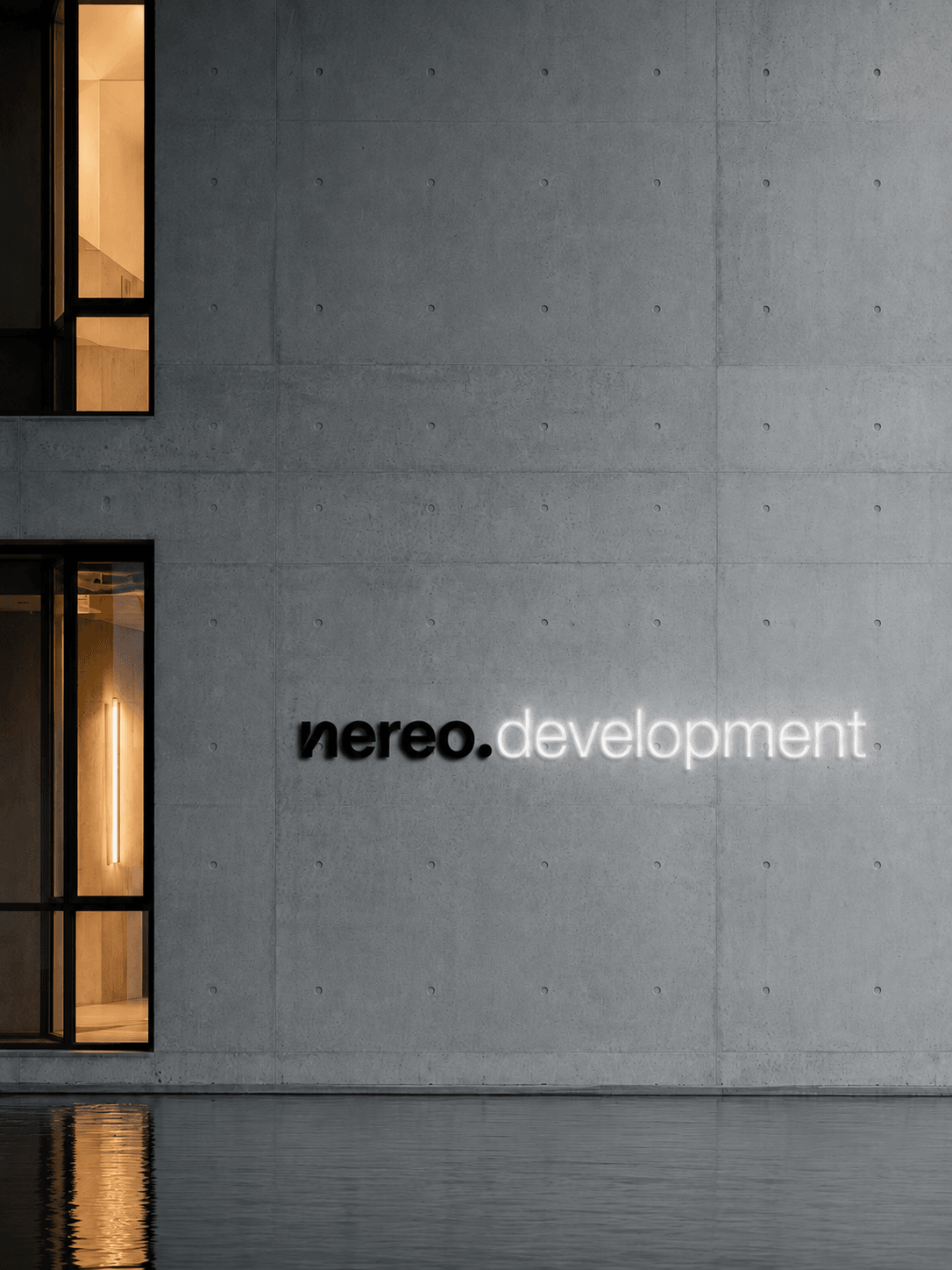 nereo.development lettering on a concrete facade