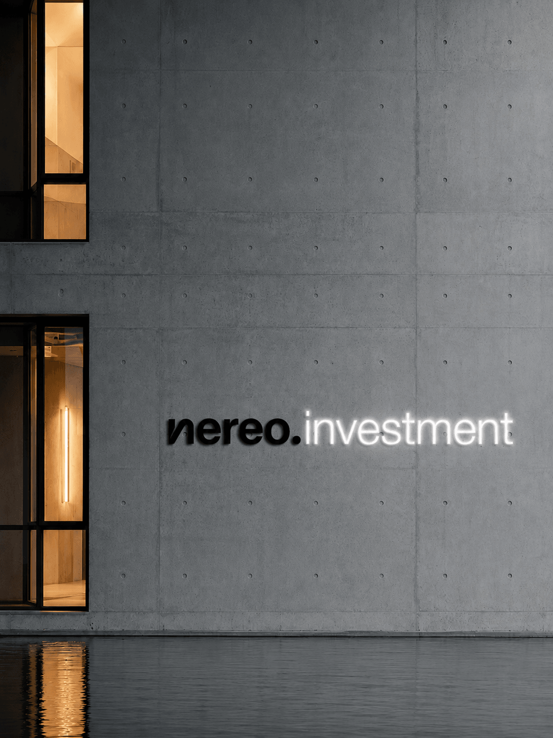 nereo.investment lettering on a concrete facade